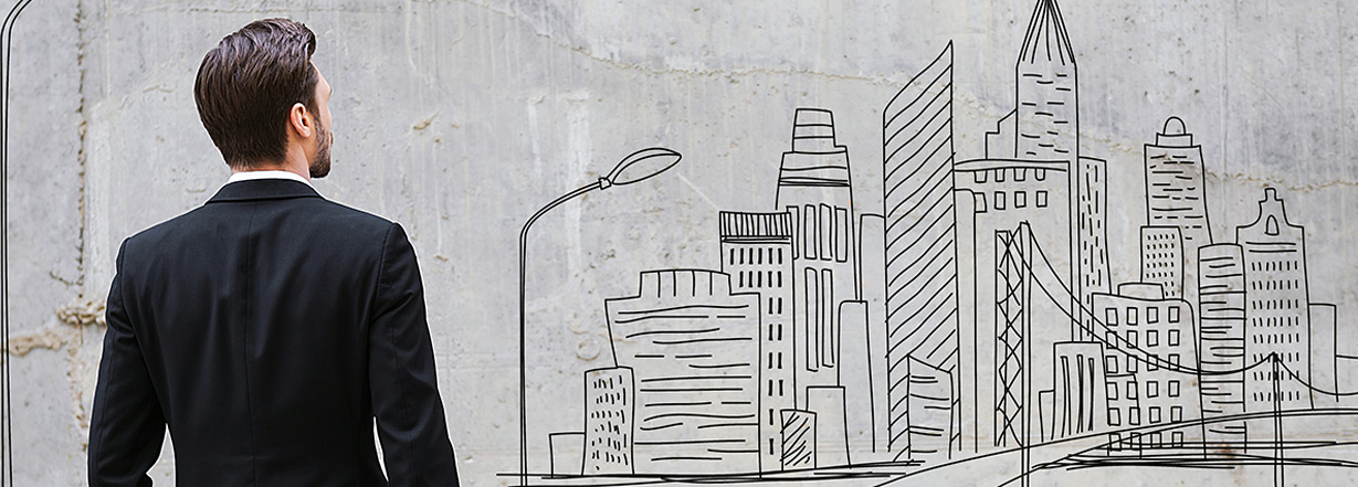 Image of teenager looking at city drawing on wall.